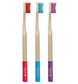 from earth to earth adult medium bristle toothbrushes, shown in red, blue and purple colourways